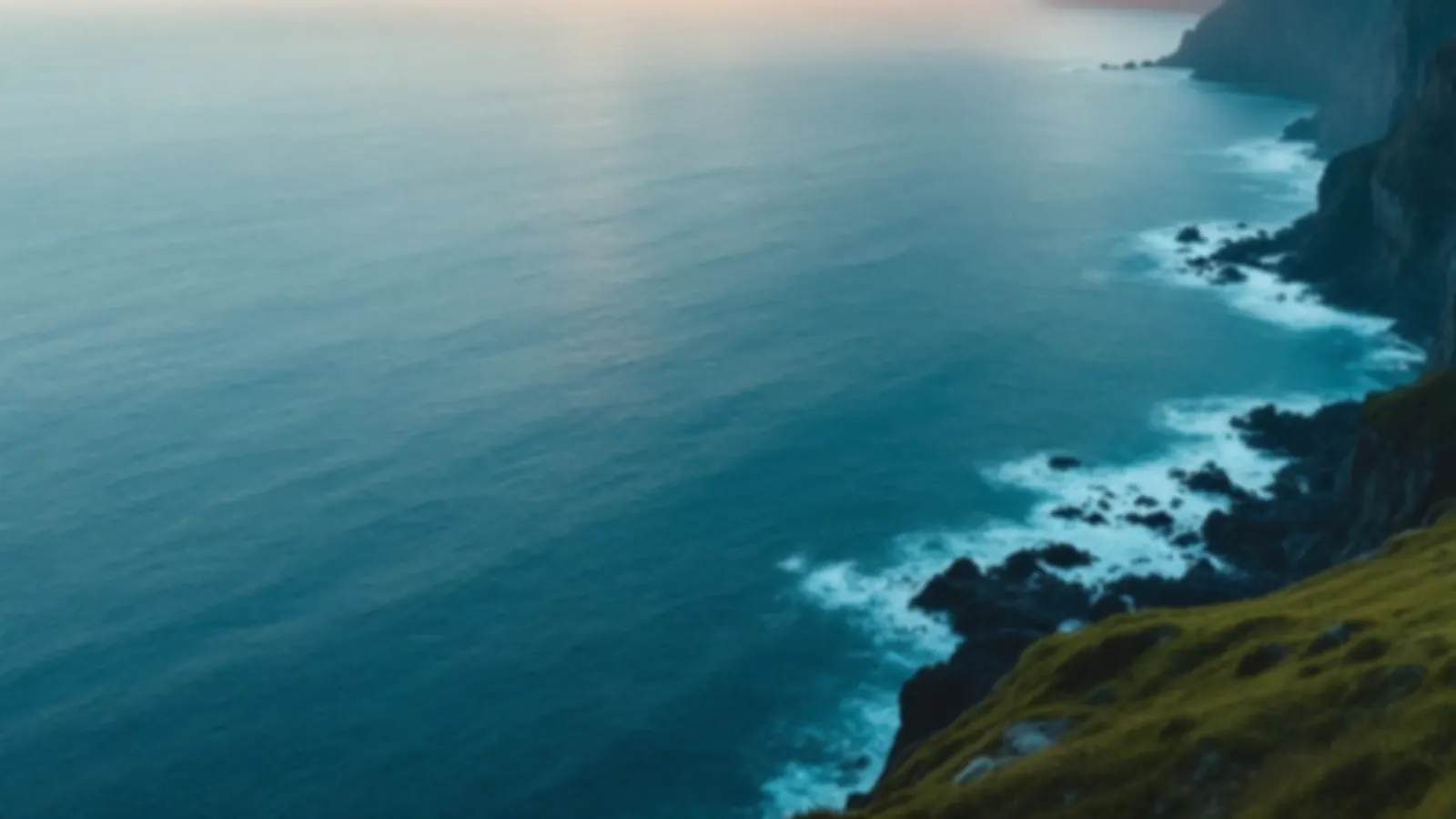 An empty coastal road winding along green cliffs above a calm blue sea at sunrise, the CoupeFinance view of personal loans online, $100 – $5,000